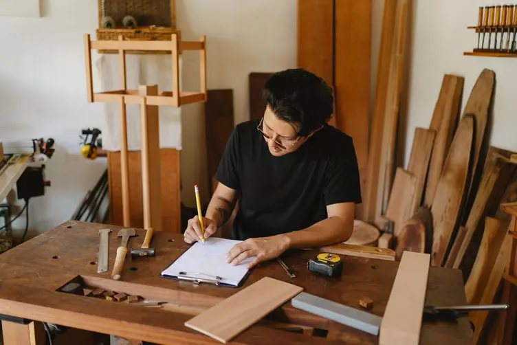 Small manufacturer reviewing shop operations at a desk