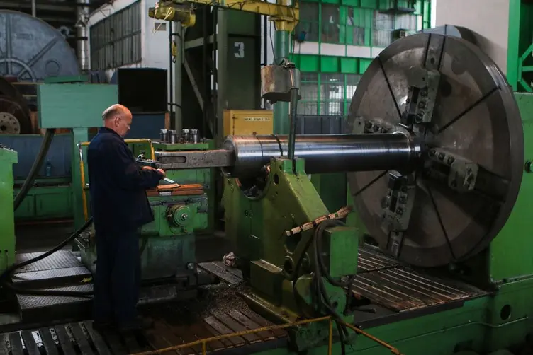Machinist checking job status at a machine