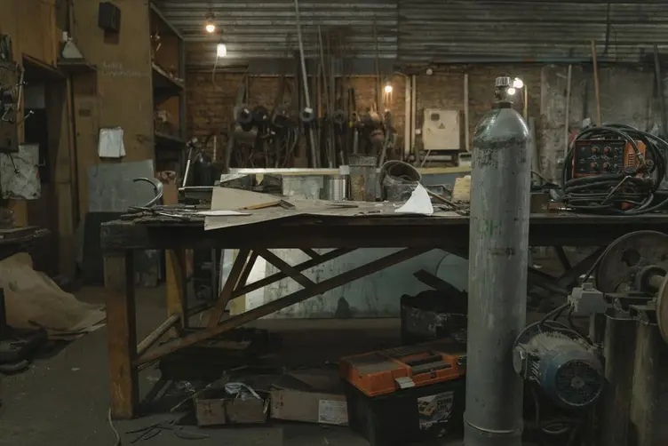 Supervisor reviewing work on a small fabrication shop floor