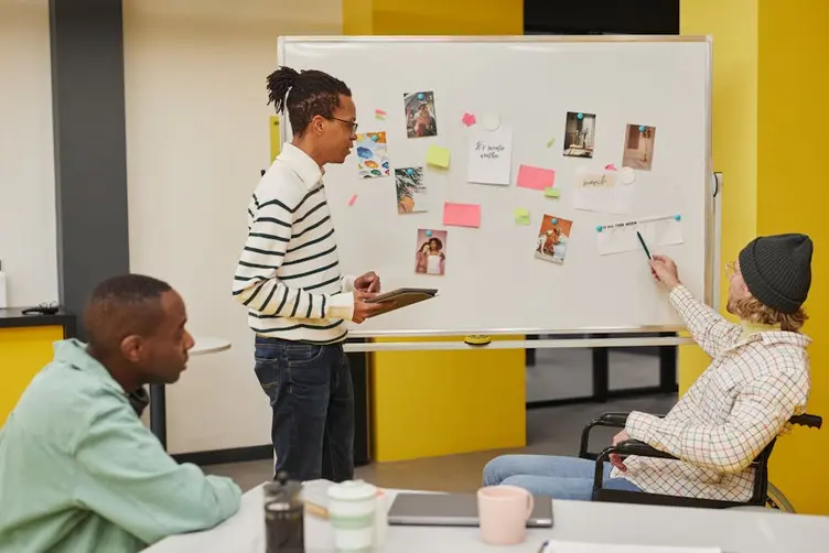 Workshop team reading a live production status board
