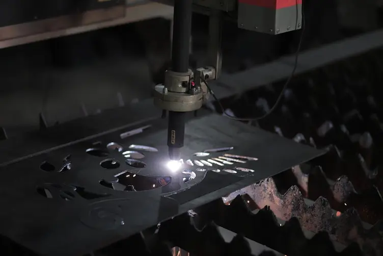 CNC plasma cutting steel plate in a fabrication shop
