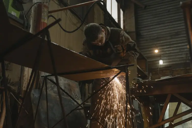 Welder in a fabrication bay waiting on the next job