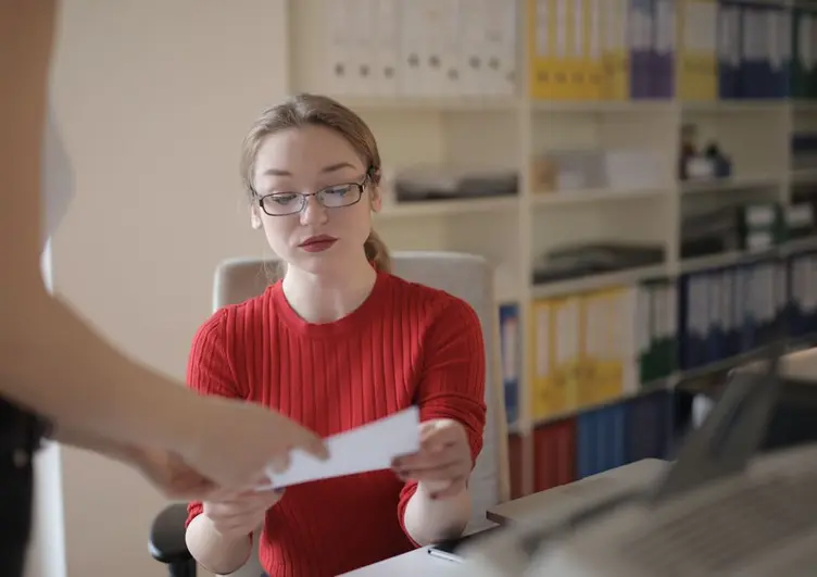 Supervisor at a desk with workshop paperwork