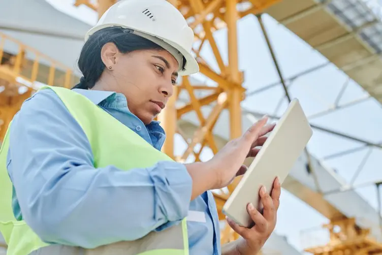 Supervisor checking jobs on a tablet on the shop floor